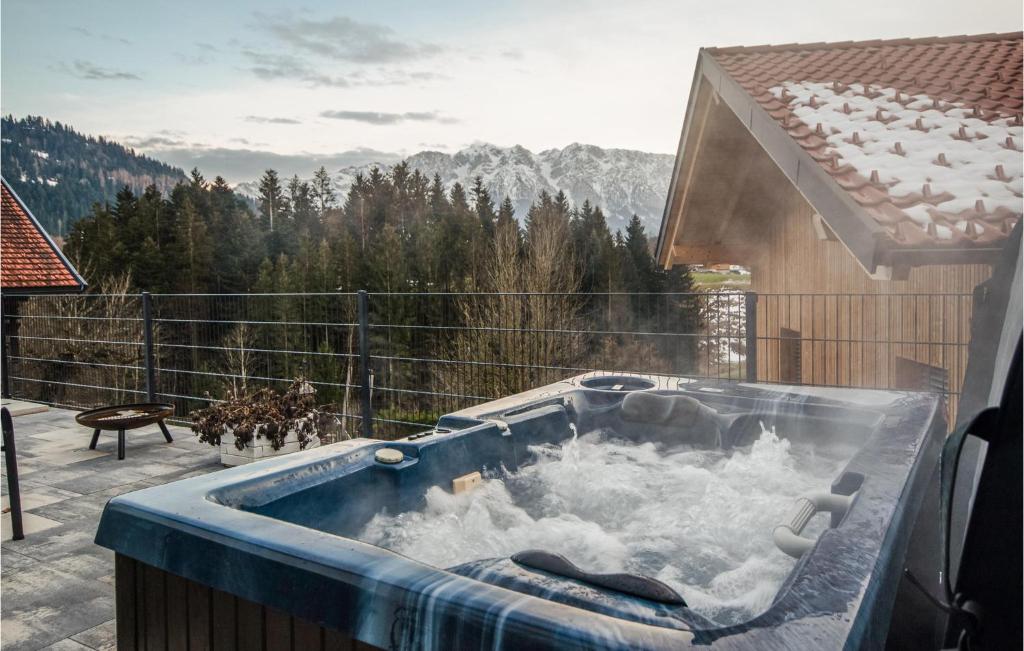 a hot tub sitting on a patio with snow at Nice Apartment In Niederndorferberg With Kitchen in Niederndorferberg