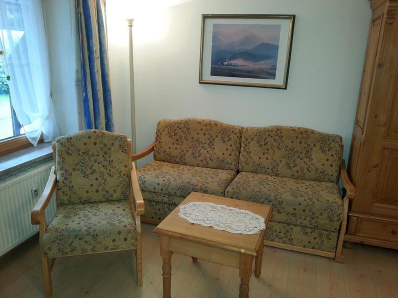 a living room with a couch and a chair at Ferienwohnung Mack in Oberstaufen