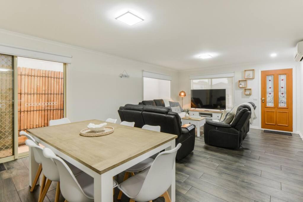 a living room with a table and some chairs at Avenue Family Retreat in Rosebud