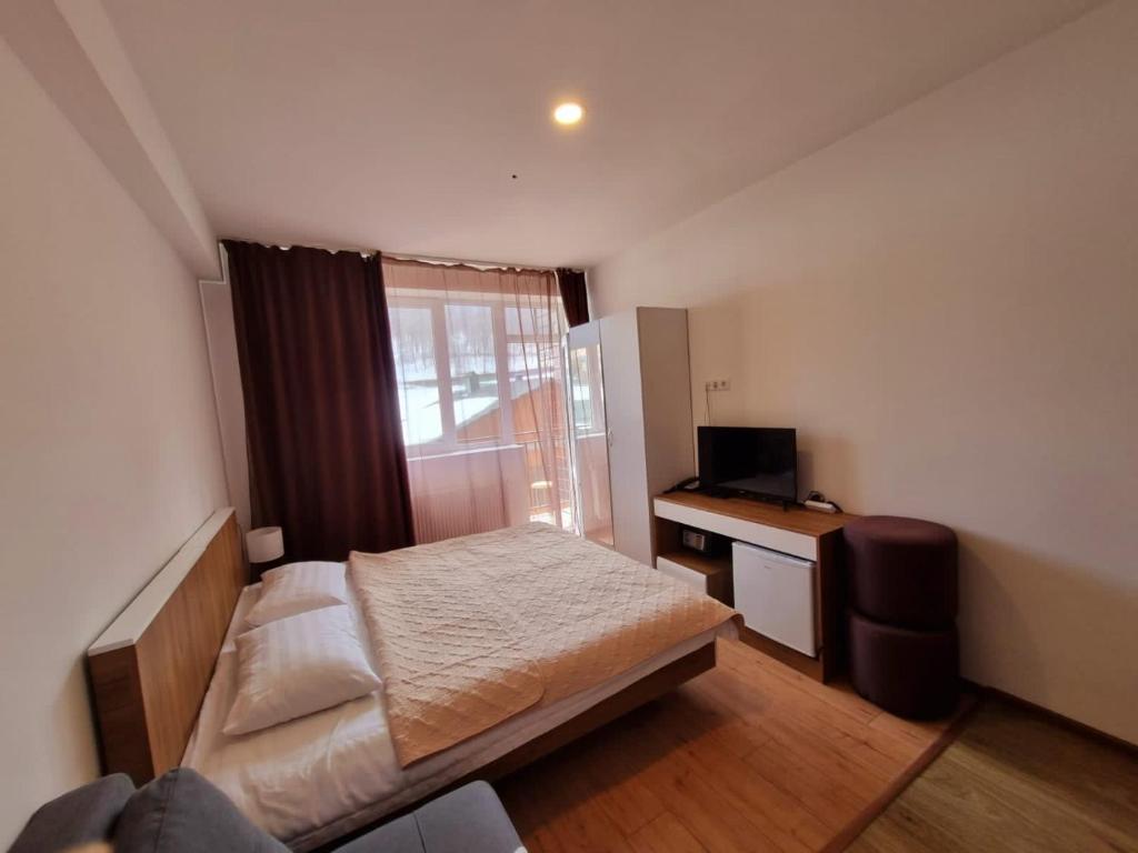 a small bedroom with a bed and a desk at Apartment in Bakuriani in Bakuriani