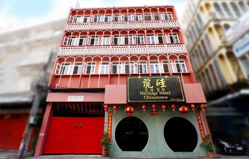 un edificio rojo alto con un cartel delante en 2499 Heritage Chinatown Bangkok Hotel By RoomQuest, en Pom Prap