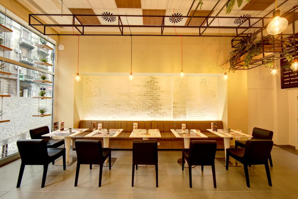 a dining room with a large table and chairs at Hotel Srbija Garden-FREE PARKING in Belgrade