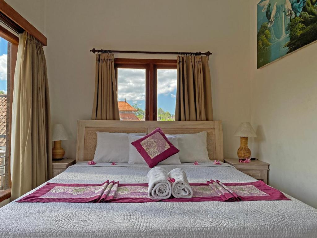 Postel nebo postele na pokoji v ubytování Ganesh Room