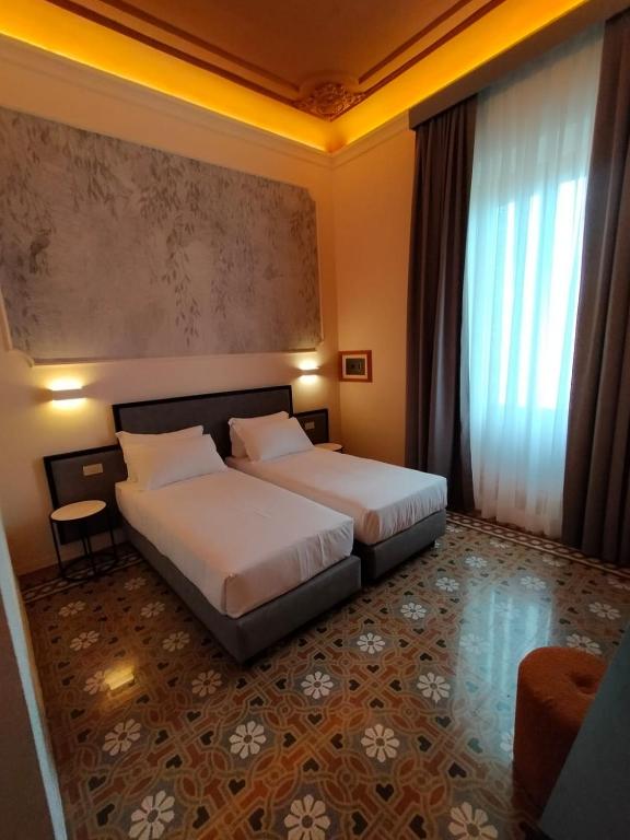 Postel nebo postele na pokoji v ubytování Hotel Fiorita