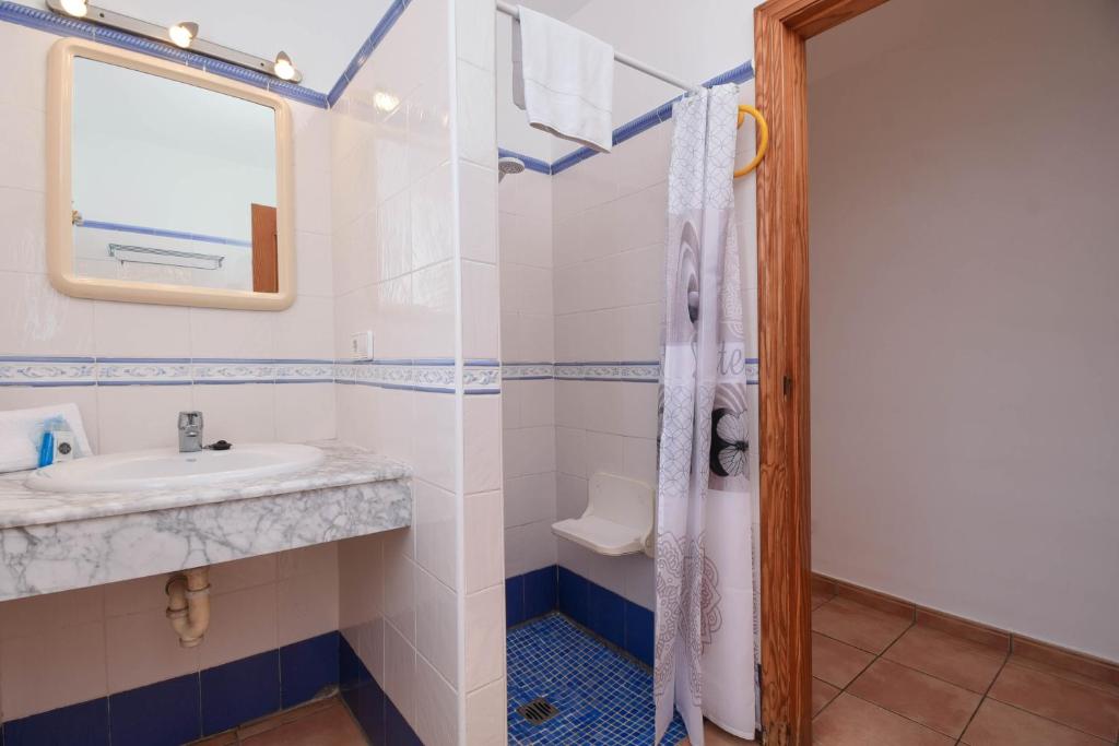 a bathroom with a shower and a sink at Monte Naranja in Jávea