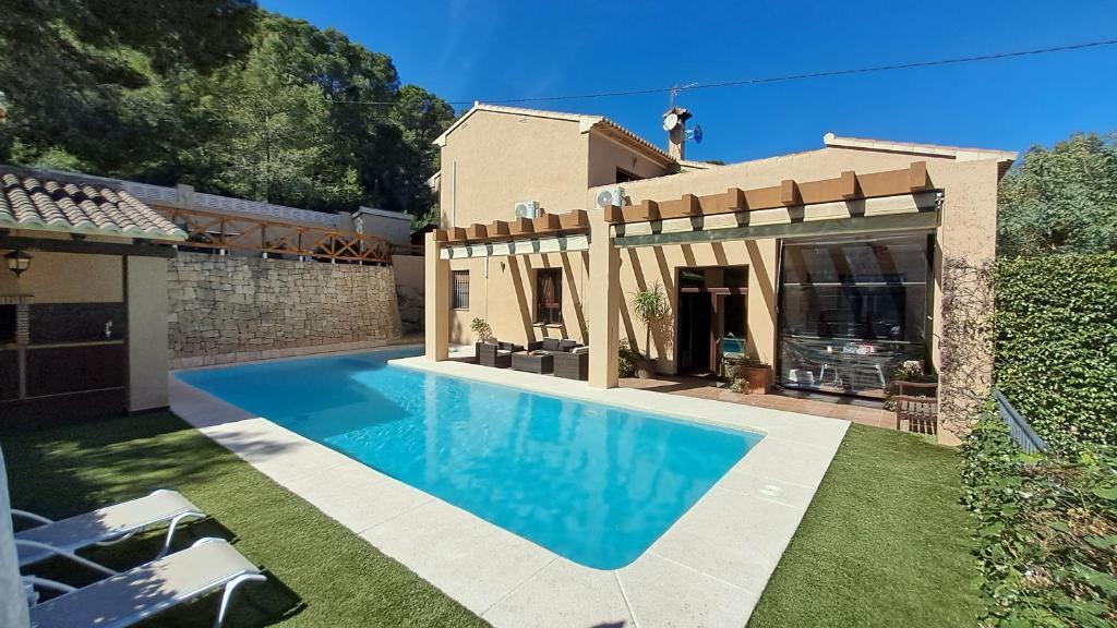 a house with a swimming pool in the yard at Casa NeGo in Calpe