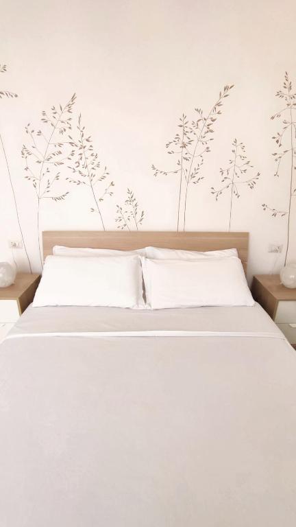 Postel nebo postele na pokoji v ubytování B&B Le Albarelle