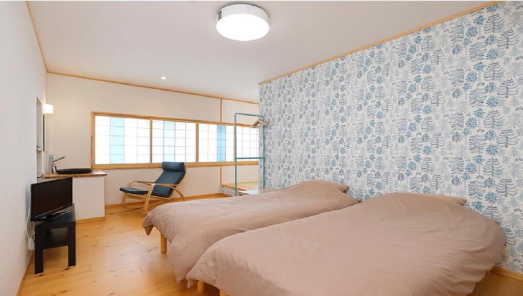 Postel nebo postele na pokoji v ubytování Onsen Petit Hotel Yukori Bandai Atami