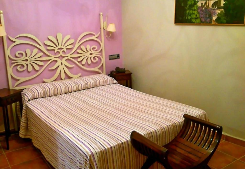 A bed or beds in a room at Al Andalus Jerez