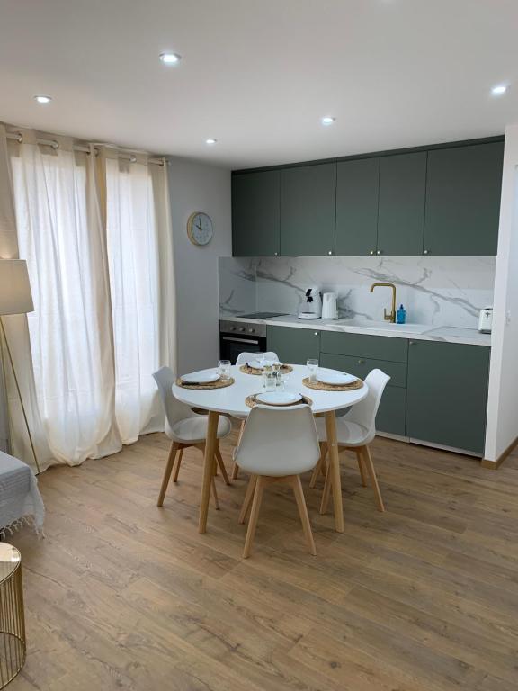 a kitchen with a table and chairs in a room at APPARTEMENT OR in Manosque