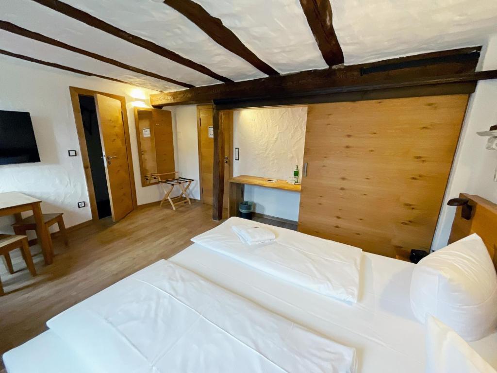 een slaapkamer met 2 witte bedden in een kamer bij Hotel Brauhaus Wiesenmühle in Fulda