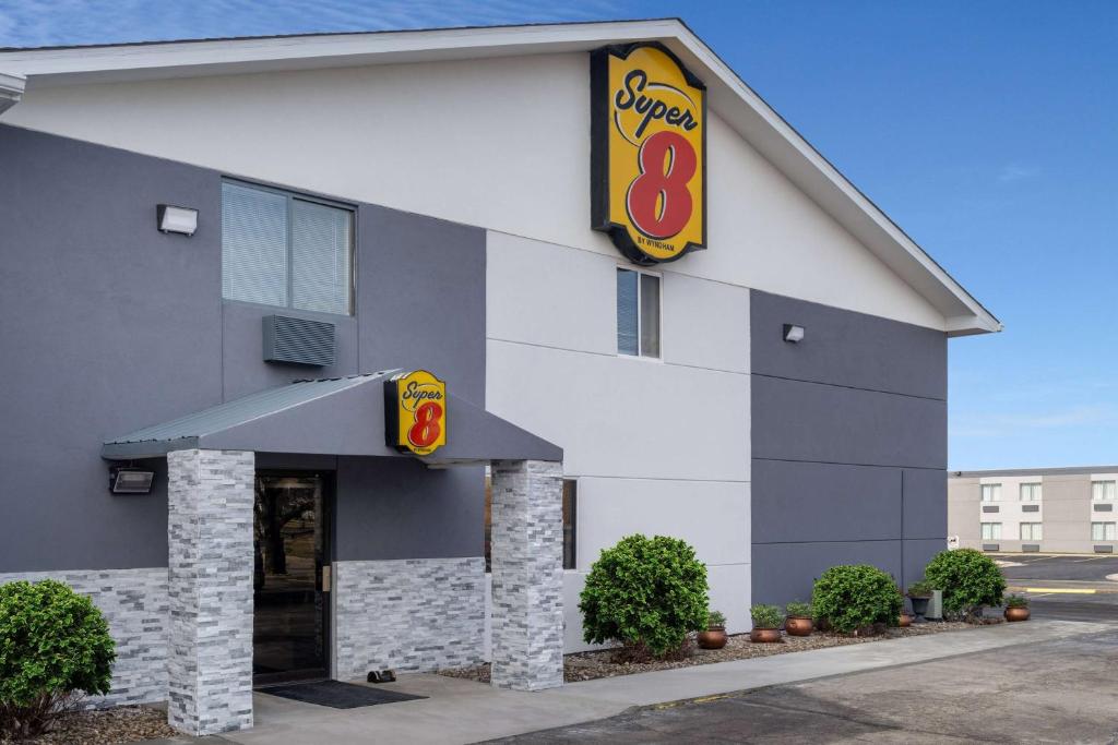 a building with a burger sign on it at Super 8 by Wyndham Merrillville in Merrillville