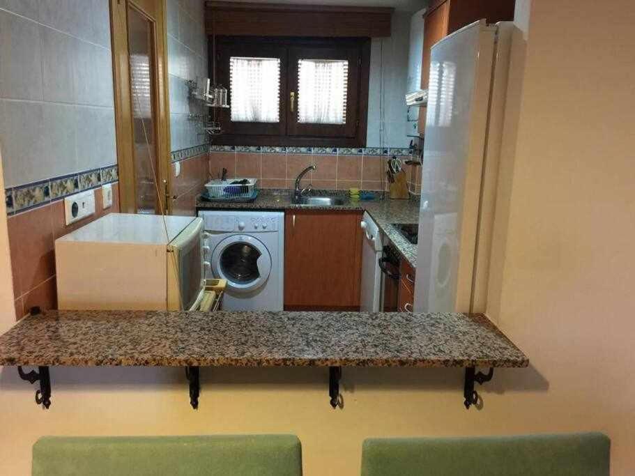 a kitchen with a washer and dryer on a counter at Apartamento Casa Valero in Rubielos de Mora