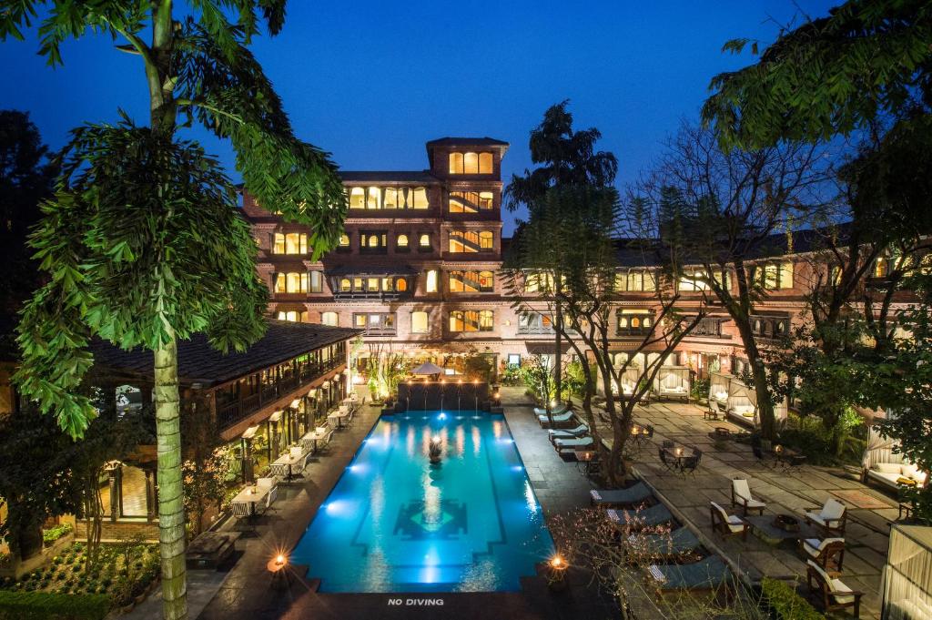 a hotel with a swimming pool at night at The Dwarika's Hotel in Kathmandu