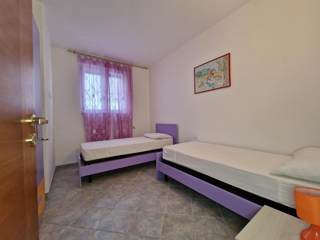 A bed or beds in a room at Casa Vacanza Maria Fronte mare