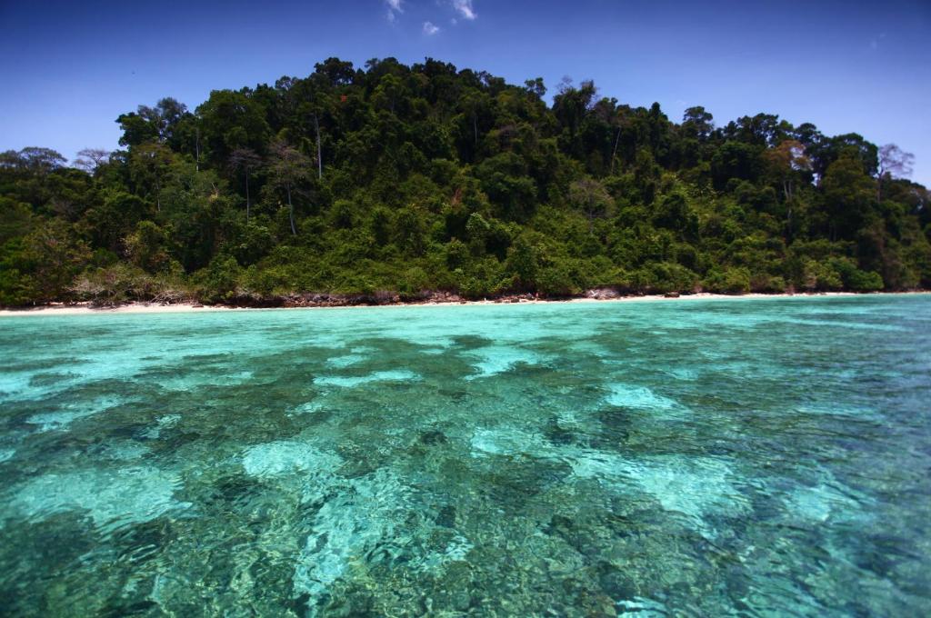 an island in the ocean with crystal clear water at Mook Lamai Resort and Spa in Ko Mook