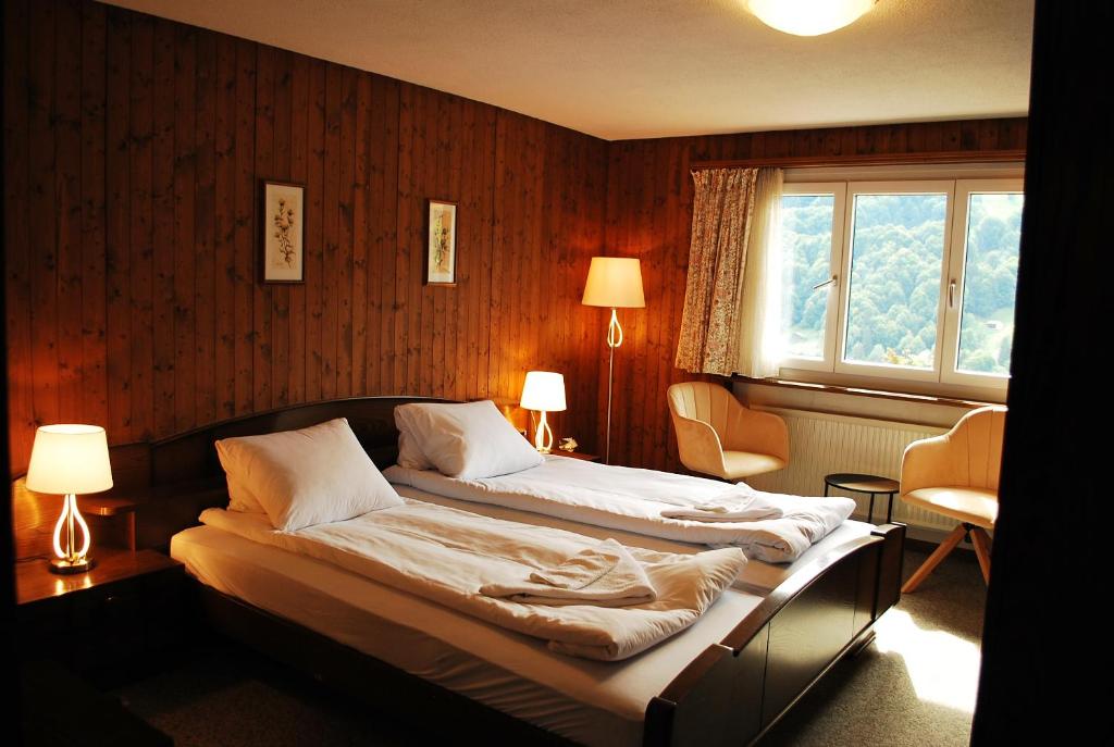 a bedroom with two beds and a window at Rooms with Private bathrooms in Saas