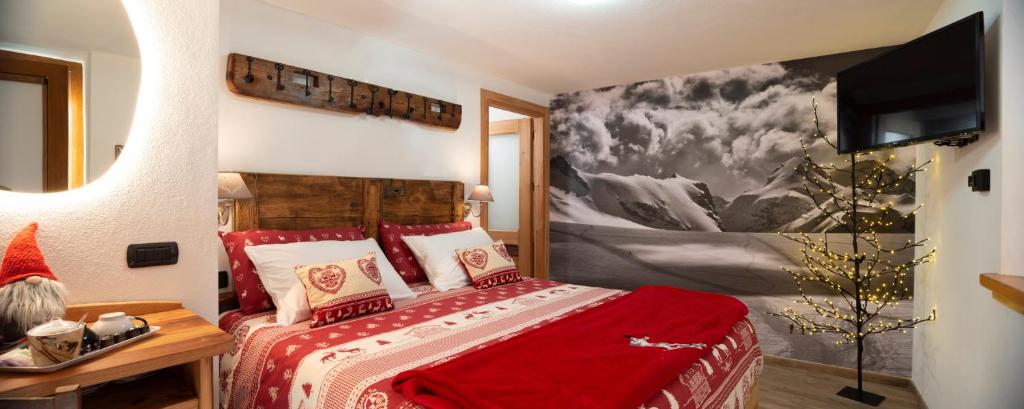 a bedroom with a bed with a red blanket at Romantica camera in Valtournenche