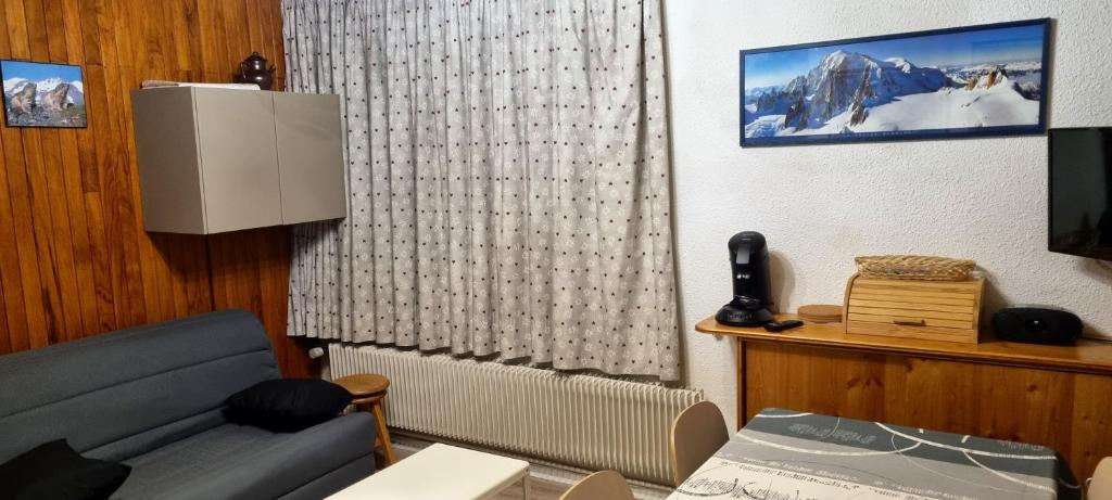 a living room with a couch and a television at Appartement d&#39;une chambre avec vue sur la ville balcon et wifi a Chamrousse in Chamrousse