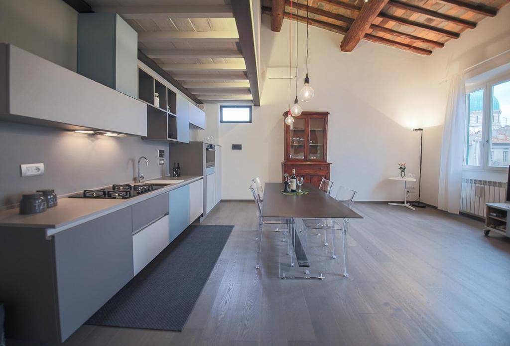 a large kitchen with a table and chairs in it at Apartments Florence Pepi attic in Florence