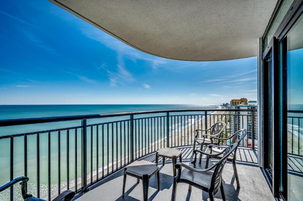 a balcony with chairs and a view of the ocean at Oceanfront 3BR Caribbean Resort Condo unit 2009 in Myrtle Beach