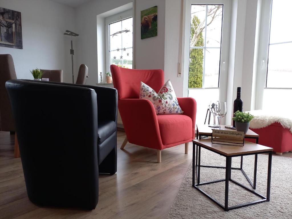 a living room with two chairs and a table at Ferienwohnung Sauerland Fernblick in Olsberg