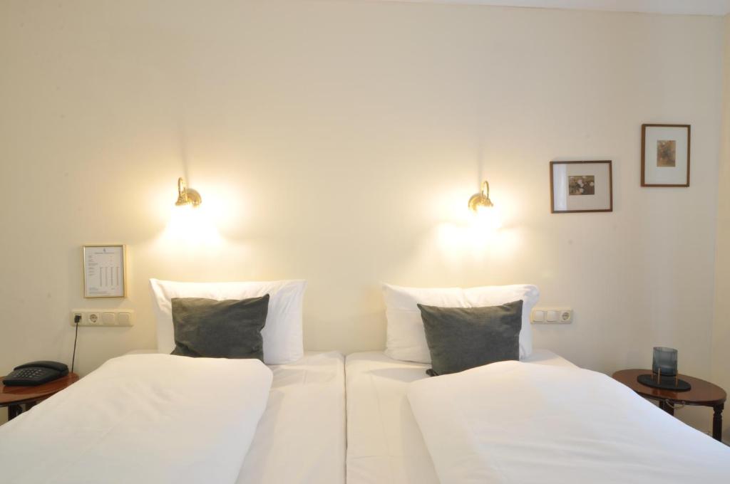 Postel nebo postele na pokoji v ubytování Hotel Altmünchen by Blattl