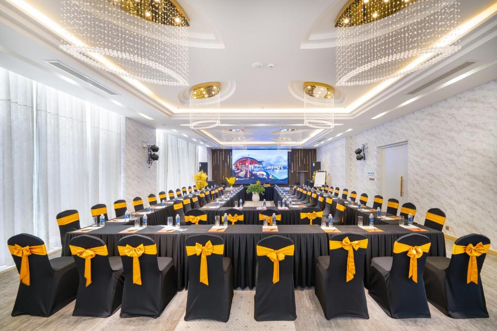 A banquet hall set for a formal event with long tables and yellow-accented chairs.