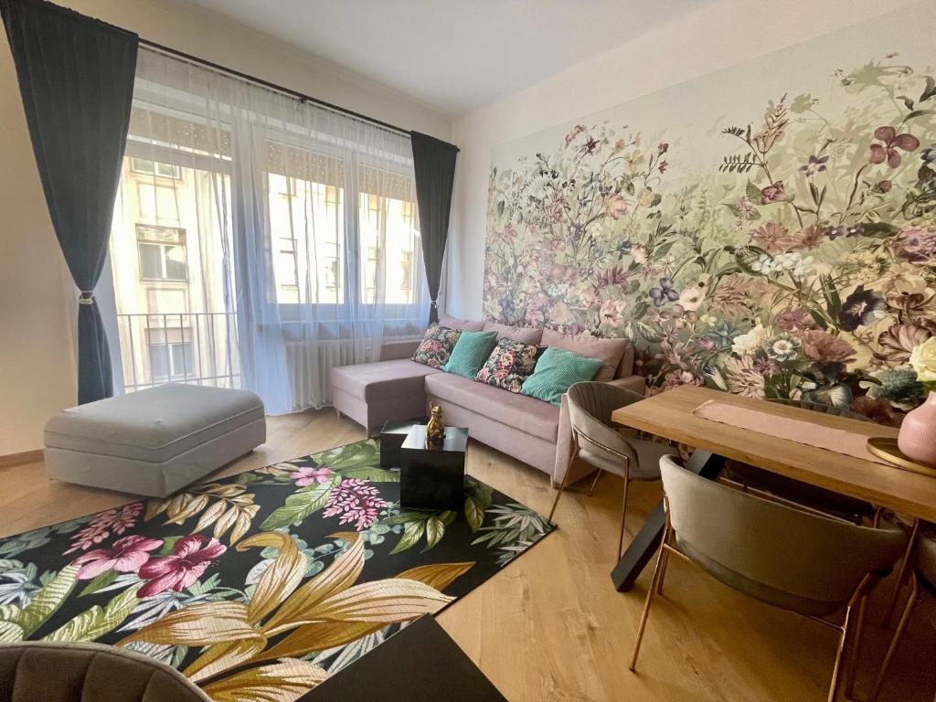 a living room with a floral mural on the wall at Brand New Apartment #Hollán#3BEDR#2BATHR#FREEPARKING in Budapest