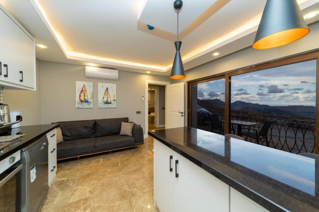 a kitchen and a living room with a couch at Flat with Jacuzzi and Sea View in Kas Antalya in Kas
