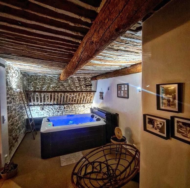 ein großes Bad mit blauer Badewanne in einem Zimmer in der Unterkunft L' ecurie de Florent et Spa in Cheval-Blanc
