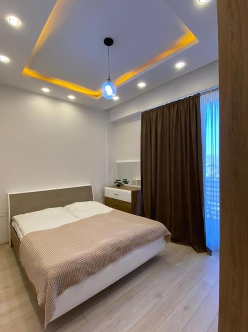 a bedroom with a bed in a room with a window at Apartment in the center Tbilisi in Tbilisi City