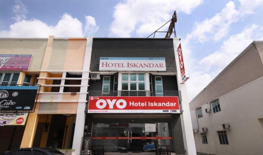 a hotel building with a hotel sign on it at Hotel Iskandar in Seri Iskandar