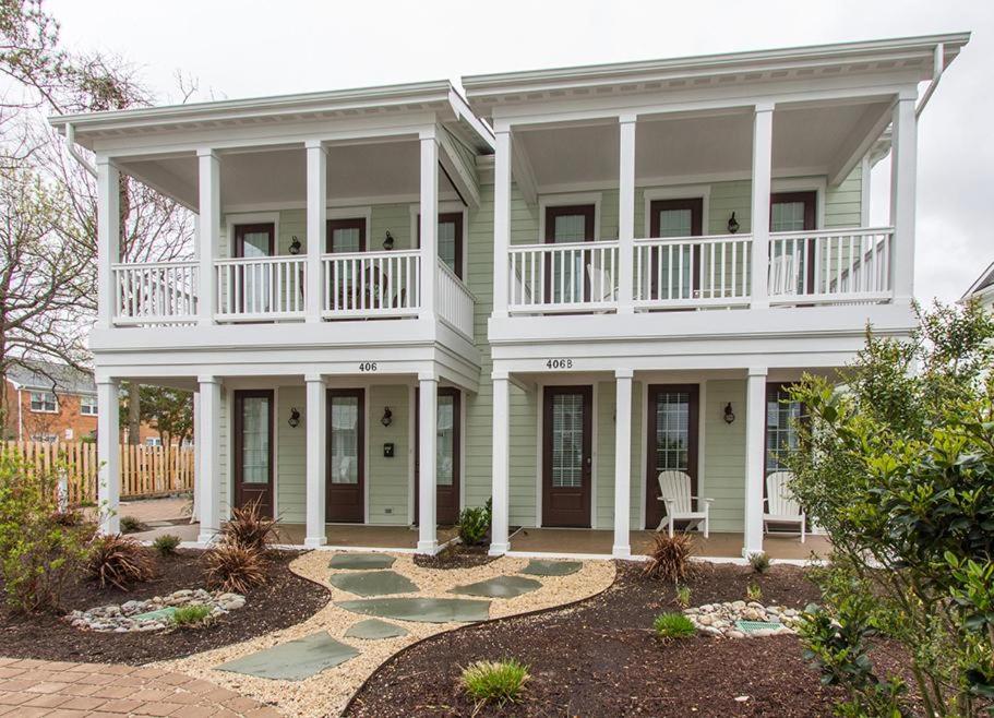 a large white house with a balcony and a patio at 406B The North End House in Virginia Beach