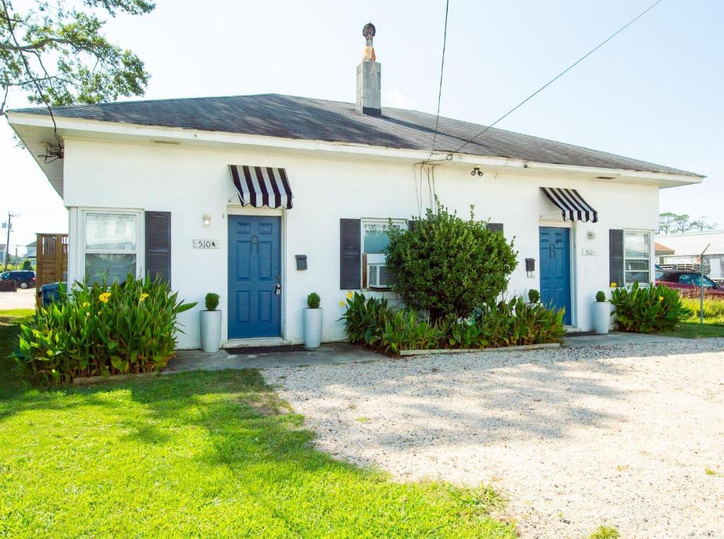 Casa blanca con puertas azules y patio en 510 A The Beach Break Bungalow, en Virginia Beach