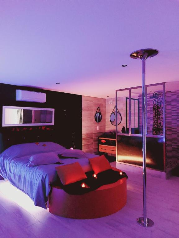 a bedroom with a large bed and a floor lamp at why not in Lédignan