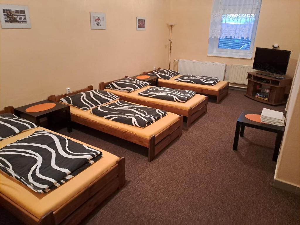 a group of four beds in a room at Ubytovani, (apartman) - sportovni hala TJ in Strážnice