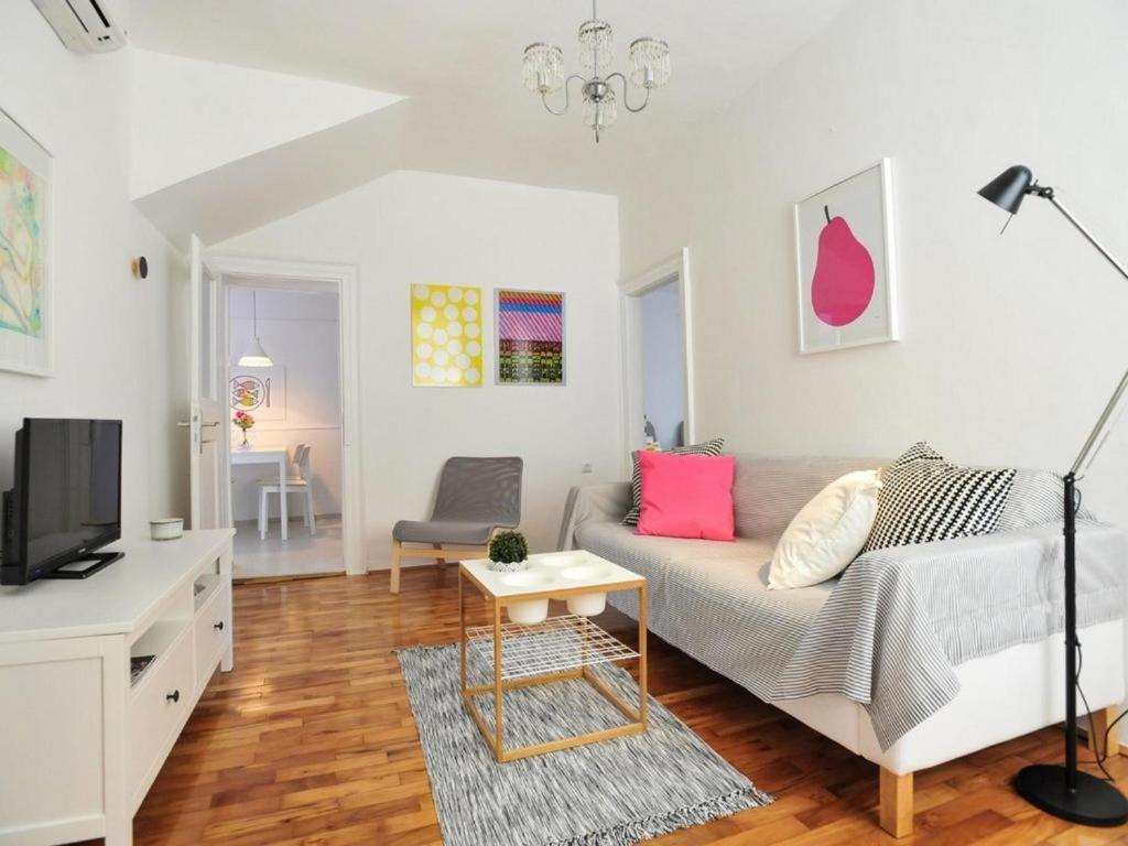 a living room with a couch and a tv at Downtown apartment Tango in Zadar