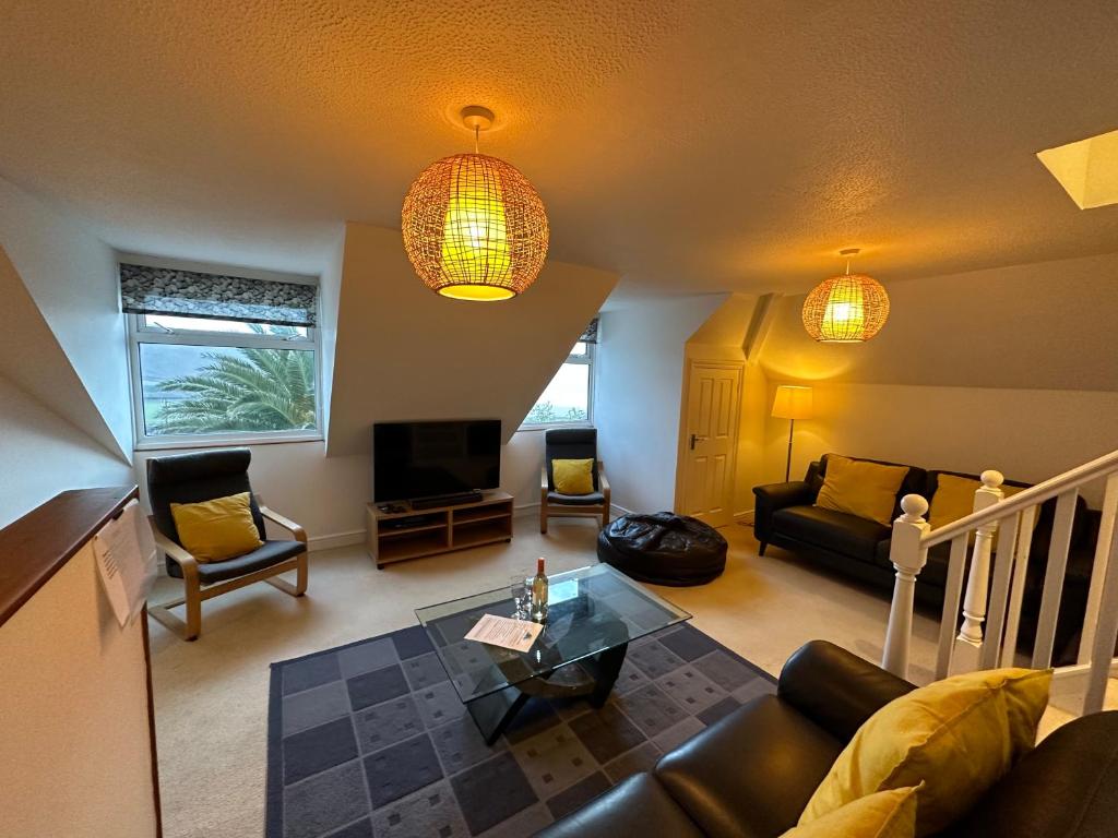 a living room with a couch and a table at Southover Beach in Woolacombe