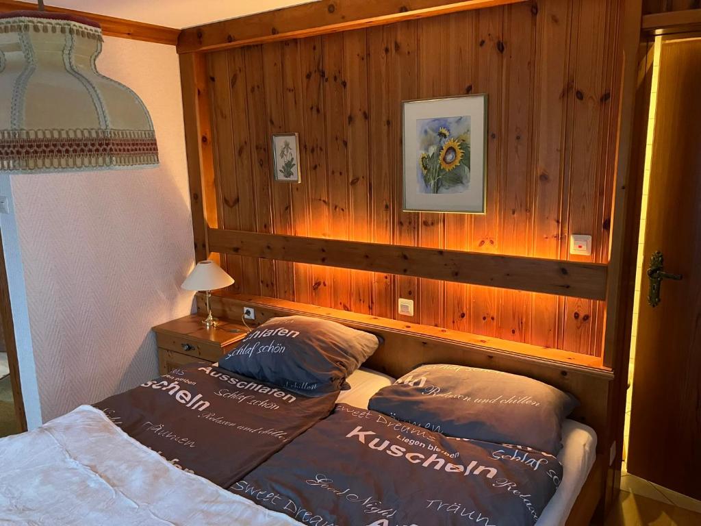 a bedroom with a bed and two pillows on it at Gästehaus Lickert Familie Dreher in Hinterzarten