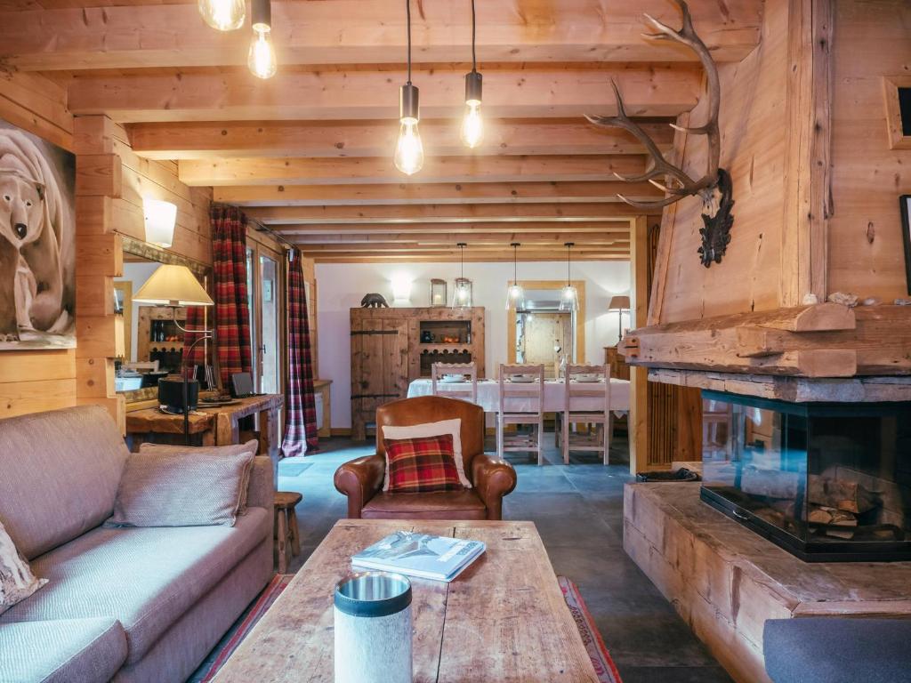 un salon avec un canapé et une cheminée dans l'établissement Chalet 4 étoiles avec WiFi et parking proche du centre à Chamonix - FR-1-343-224, à Chamonix-Mont-Blanc