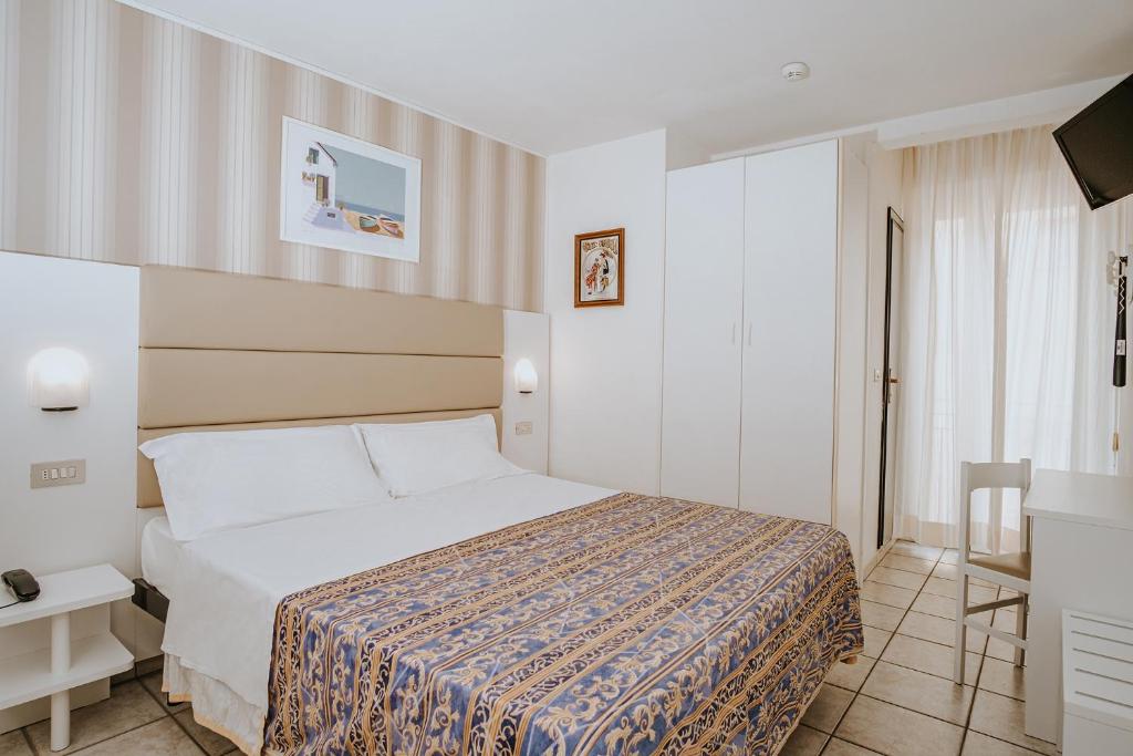 Postel nebo postele na pokoji v ubytování Hotel Gabriella