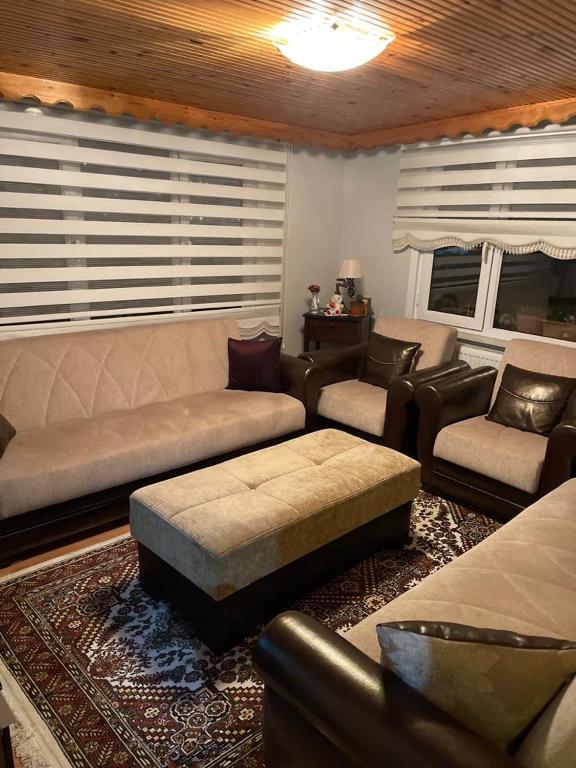 a living room with a couch and a table and chairs at Zeytinburnu in Istanbul
