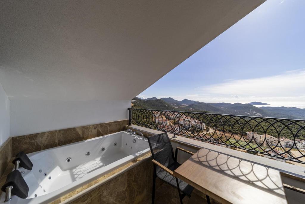 a bath tub on a balcony with a view at Gorgeous Flat with Sea View Jacuzzi in Antalya Kas in Kas