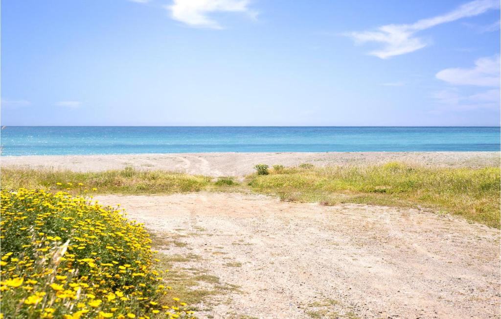 a dirt road leading to a beach with the ocean at 4 Bedroom Stunning Apartment In Rogliano in Rogliano