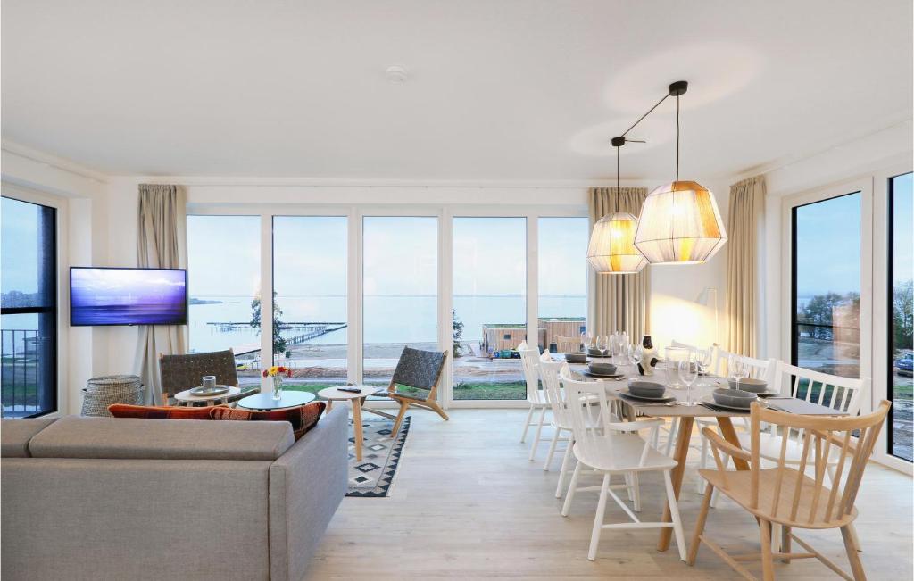 a living room with a long table and chairs at Penthouse Deluxe in Lembruch