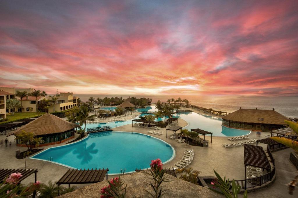 an aerial view of a resort swimming pool at sunset at La Palma Princess in Fuencaliente de la Palma