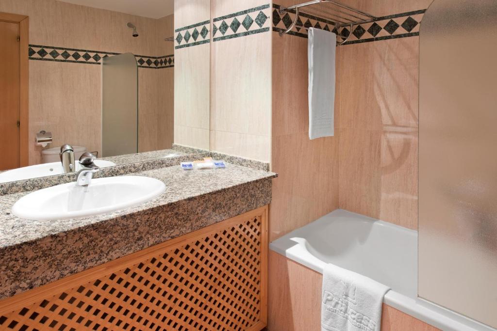 a bathroom with a sink and a bath tub at Fuerteventura Princess in Playa Jandia