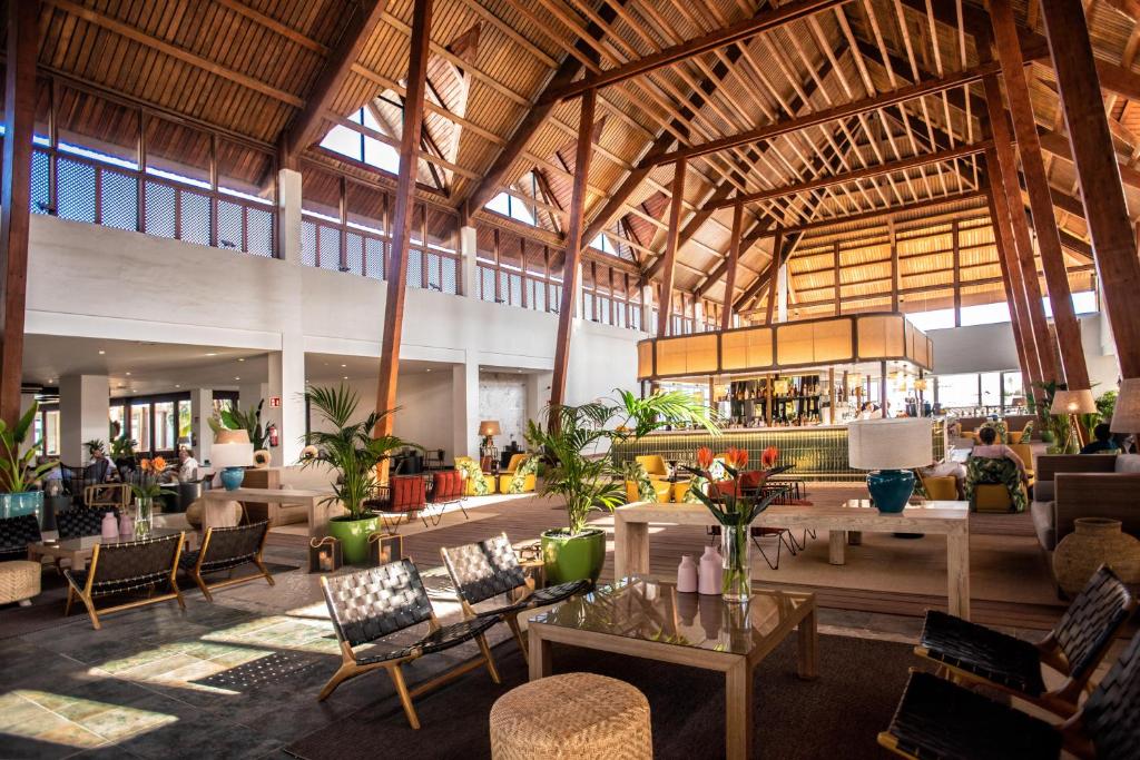 a large building with a lobby with tables and chairs at Fuerteventura Princess in Playa Jandia