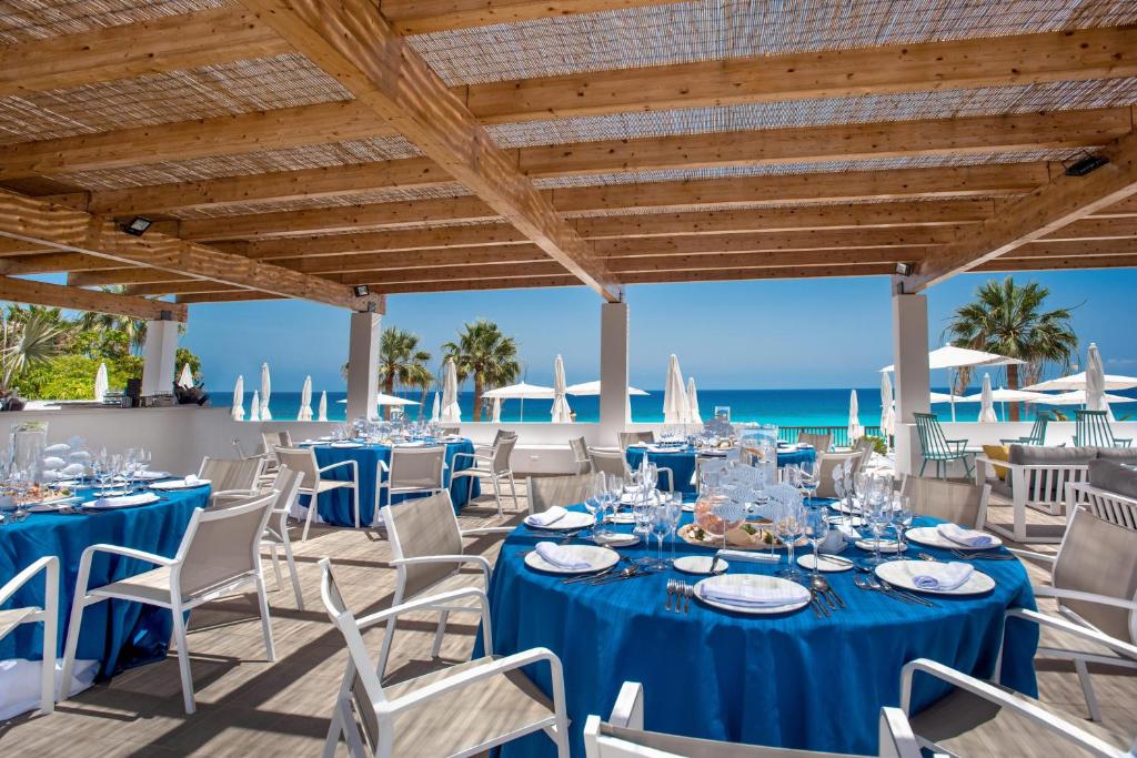 a wedding reception on the beach with blue tables and chairs at Fuerteventura Princess in Playa Jandia